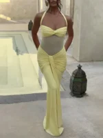 Elegant yellow dress with ruched details and halter neckline.