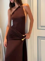 Woman in elegant brown dress with asymmetrical shoulder design.