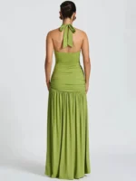 Green halter neck maxi dress with ruched bodice and flowing skirt.