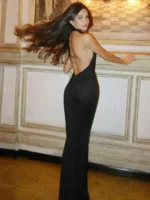 Elegant woman in black evening gown with flowing hair at Thrive Store event.