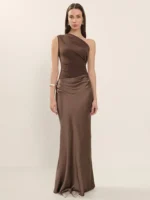 Woman in brown satin evening gown with one-shoulder design, full-length, elegant style.