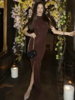 Elegant woman in brown dress standing at Thrive Store with floral backdrop.