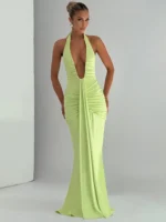 Woman in a stylish lime green evening gown with deep neckline.