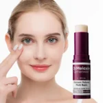 Woman applying skincare balm with Dr. Melaxin Cemenrete product on her face.
