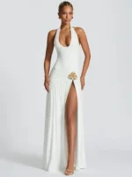 Woman wearing a white maxi dress with a high slit, stylish and elegant for special occasions.