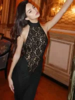 Elegant woman in black lace dress at Thrive Store, showcasing stylish fashion and modern interior de.