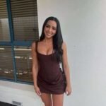 Woman smiling in brown dress outside Thrive Store.