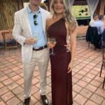 Elegant couple at Thrive Store event, enjoying drinks outdoors.