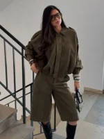 Stylish women in khaki oversized jacket and wide-leg pants, fashion-forward look, fall outfit.