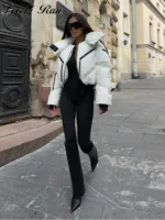 Oversized white puffer jacket with black accents, stylish streetwear outfit, urban fashion, Thrive Store.