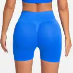 Woman wearing high-waisted blue athletic shorts for activewear and fitness.